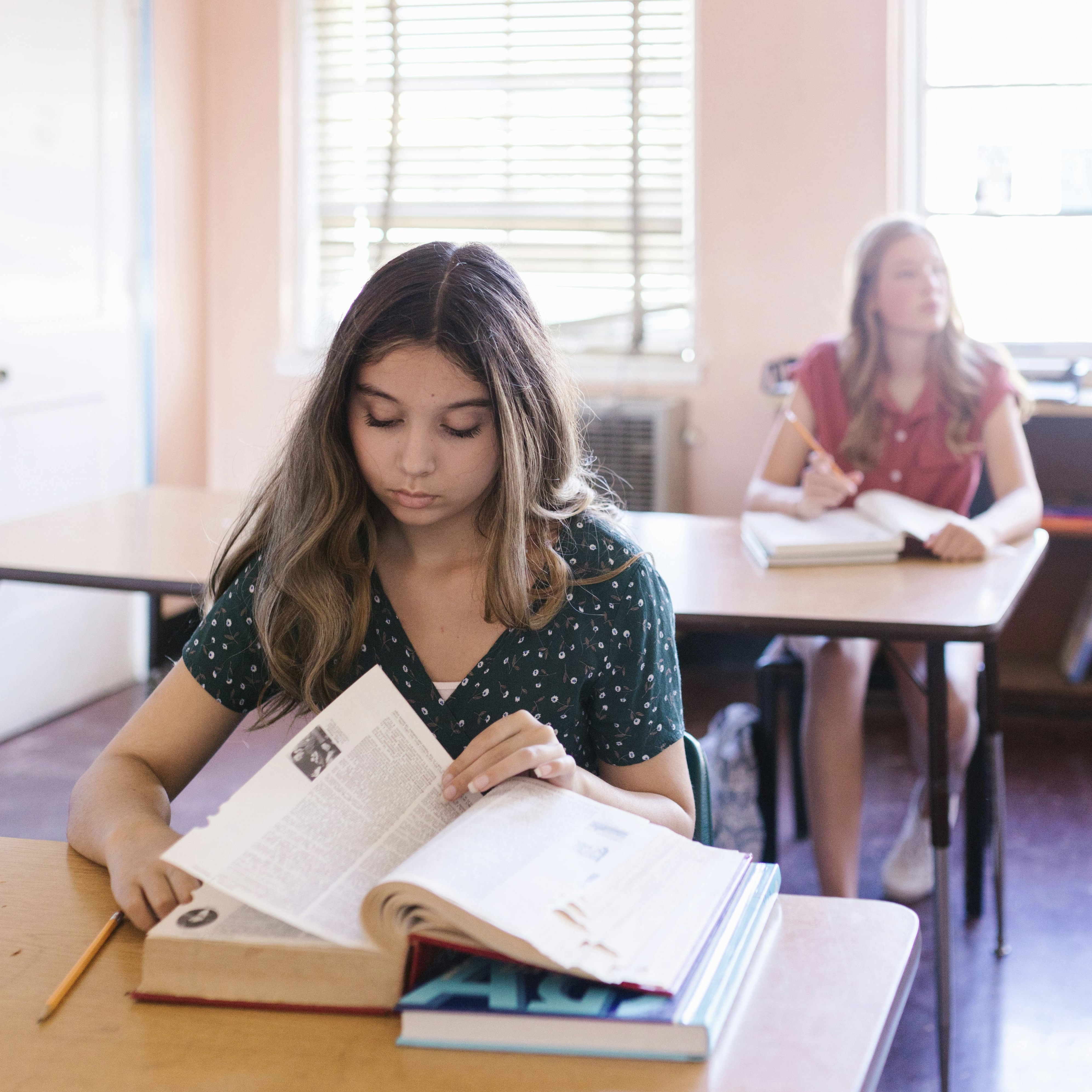 Female student reading a book.