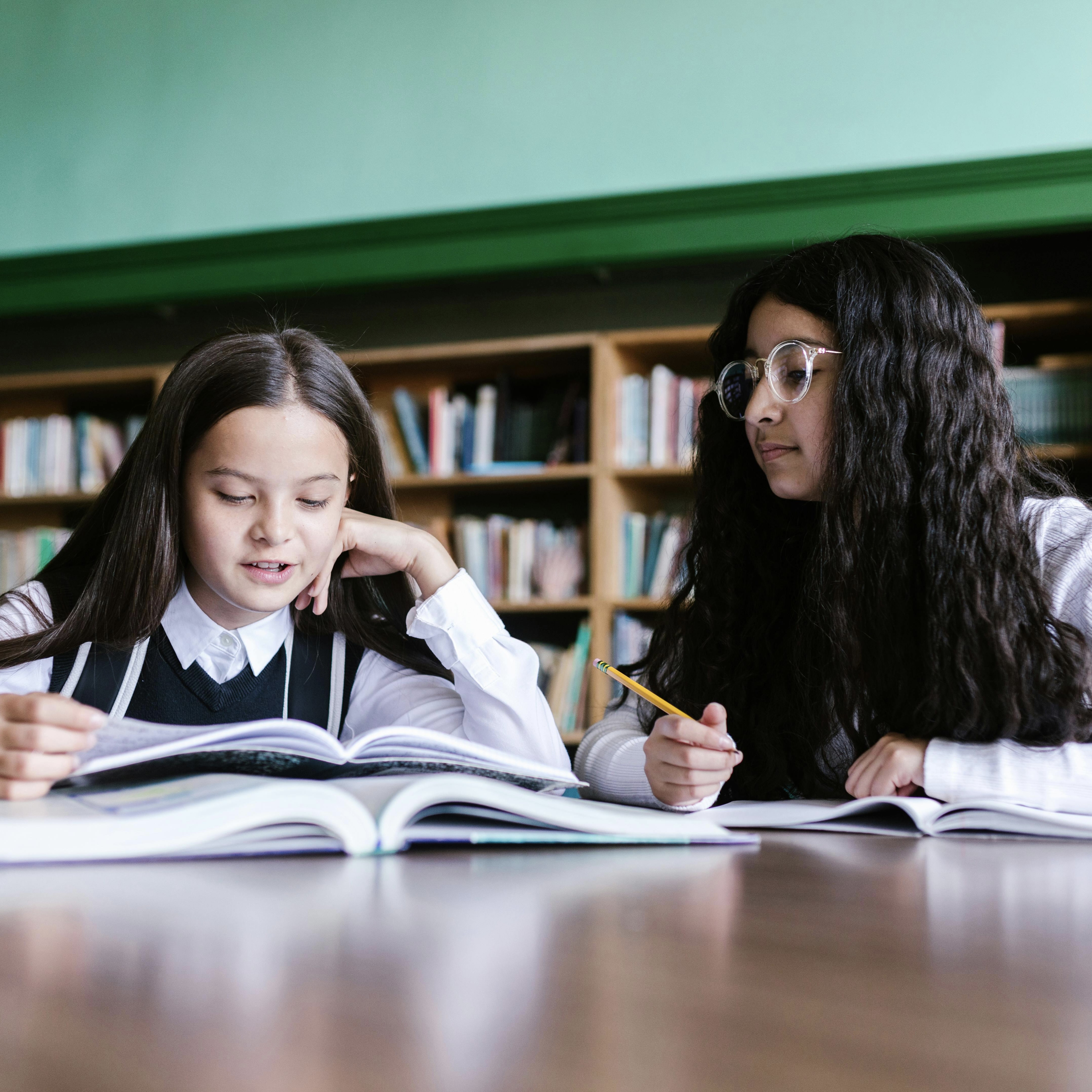 Two female students doing schoolwork.